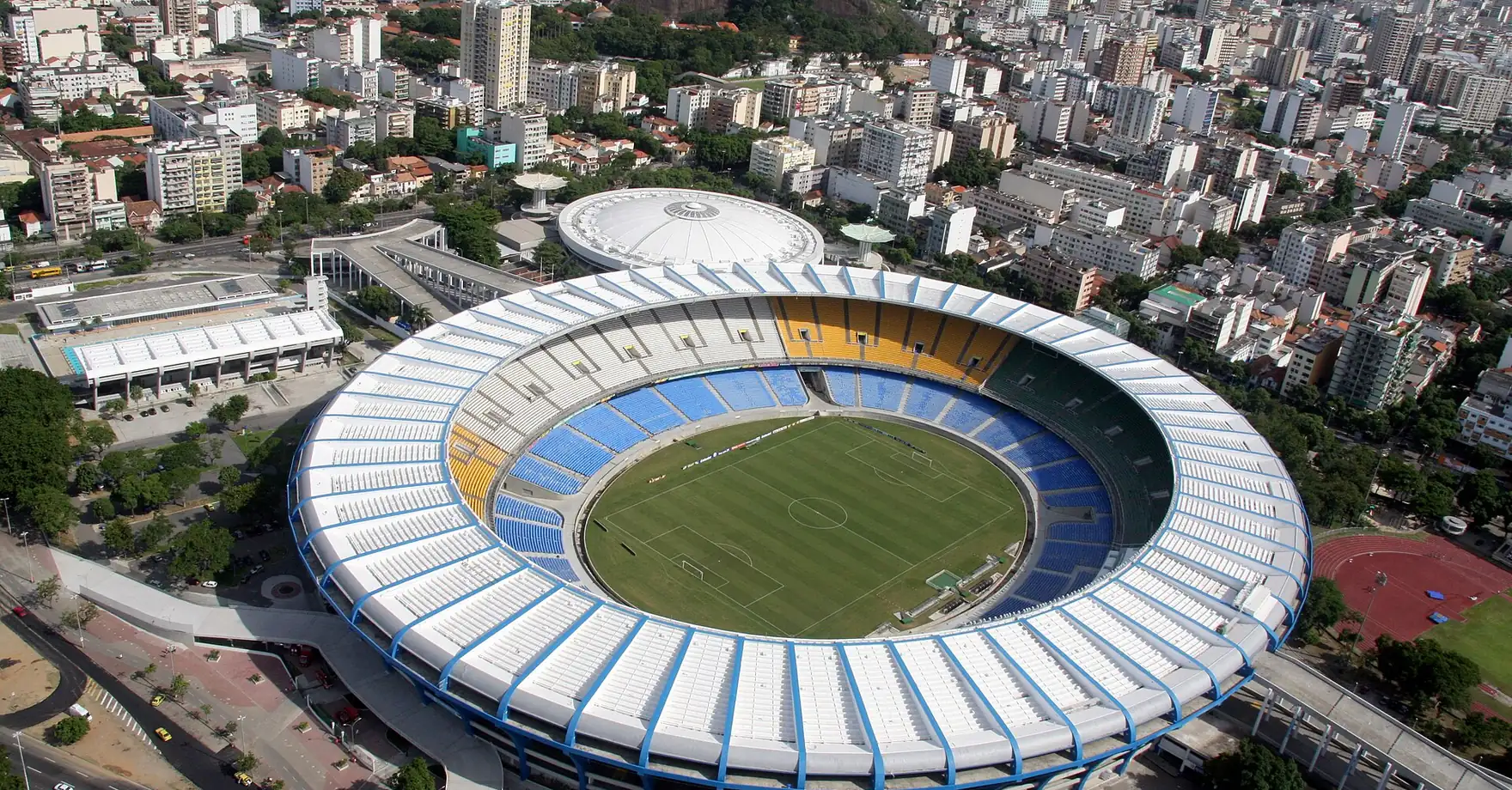 Aerial view of the Maracanã: the stadium ringed by apartment blocks and neighborhood streets that run right up to its perimeter, in Rio de Janeiro’s Zona Norte.